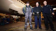 contributors in Hangar with plane in background