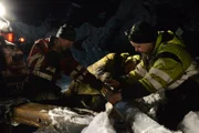 Odda, Norway - (Left to Right) Tor Steinar Tveit, Thord Paulsen and Olav Eike are trying to remove the road safety barriers. It´s in their way and makes problems for them to rescue the heavy vehicle in the ditch.