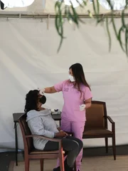 Dr. Sandra Lee examines Tiffany’s eye lump in the covid tent.