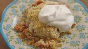 Close up of Fruit Crisp on a Plate, with Whipped Cream