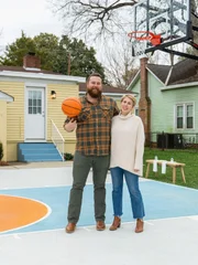 As seen on Home Town Takeover, Ben and Erin Napier pose outside of the Rose House.