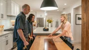 As seen on HGTV’s Help! I Wrecked My House, the Traficantes react as host Jasmine Roth reveals their new dining room featuring a custom-made oak table with a steel plate bearing the family mantra "Explore".(Reveal). .