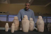 Saqqara, Egypt - Dr. Ramadan Hussein examines the unprecedented set of six canopic jars discovered inside the burial chamber of Didi-Bastet. It was the norm to only be buried with four. (National Geographic/Piers Leigh)