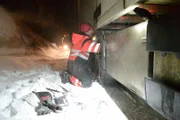 Eidfjord, Norway - Bjørn Lægreid, main cast in Eidfjord is rescuing a truck on a slippery and snowcapped road. Fixing the chains.