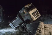 Odda, Norway - A truck has driven out of the road. It has one wheel on the road and two wheels in the ditch.   (National Geographic)