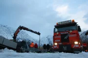 EIDFJORD, NORWAY - Bjørn Lægreids tow truck with snowy mountains in the back. Preparing for a boat rescue.