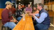 Tim hangs out with friends at an axe-throwing bar in Dallas