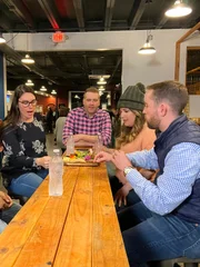 Tim hangs out with friends at an axe-throwing bar in Dallas