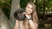 Bindi Irwin holding Echidna at Australia Zoo.