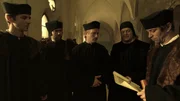 Jan Hus (Matej Hádek, mitte), Stephan von Palec (Jan Dolanský, rechts) und ihre Kollegen diskutieren ueber einen paepstlichen Erlass.