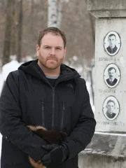 Josh Gates contemplates the Dyatlov Pass Memorial.