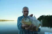 Jeremy Wade with Piranha. Parana River bank, Argentina.