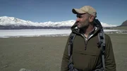 Close-up of Ed Stafford near frozen lake.