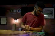 Brey looking at his phone while out with friends