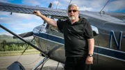 Bruce Pearson, who was told a story by his father about an Alaskan dark pyramid, stands in front of a plane as he prepares to go in search of it.