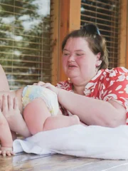 Parents Amy & Michael play with baby Gage at the family’s vacation cabin.