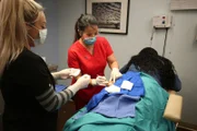 Dr. Lee preforms surgery.