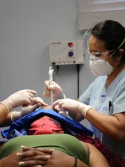 Dr. Lee and assistant work to remove Shoshana’s forehead lump.