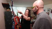 Debbi showing Jackson Galaxy her painted guitar.