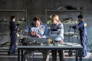 Ayr, ON - REENACTMENT - Lorenda Ward, played by Marnie Robinson and an NTSB crash investigator, played by Dimitri Vantis, inspect a cracked actuator as other NSTB crash investigators, played by background performers, assess evidence. (Cineflix 2017/Darren Goldstein)