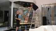 Wayde and Brett put sand in the tank.