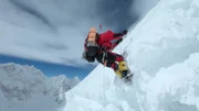 The mountaineer descends over the snow.
