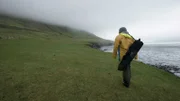 Forrest Galante walks along the shoreline.