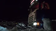 Odda, Norway - The truck that needs help is attached to a wire to get help on the slippery road.   (photo credit: National Geographic)