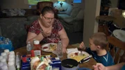 Ashley eats a meal with her son Patrick.