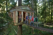 ISSAQUAH, WASHINGTON, APRIL 23 2013: Left to Right, Treehouse Masters' Charlie Nelson, Alex, Daryl, Pete Nelson and Chuck pause in front of the Temple of the Blue Moon treehouse at Treehouse Point.