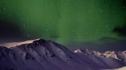 Aurora borealis over the mountains in Alaska