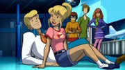 In the back, L-R: Velma Dinkley (voiced by Mindy Cohn), Shaggy Rogers (voiced by Matthew Lillard), Daphne Blake (voiced by Grey Griffin). In the front L-R: Fred Jones (voiced by Frank Welker), Melanie Staples (voiced by  Lacey Chabert)