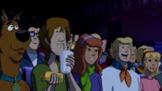 L-R: Scooby-Doo (voiced byFrank Welker), Shaggy Rogers (voiced by Matthew Lillard), Daphne Blake (voiced by Grey Griffin), Fred Jones (voiced by Frank Welker), Melanie Staples (voiced by Lacey Chabert)