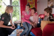 Melanie (Sanna Englund, l.) befragt Sophie Heuk (Sanne Schnapp, 2.v.r. ) und deren Kinder Rieke (Leonie Brunnert, 2.v.l.) und Lukas (Lucas Reiber, r.) zu dem Drogenfund in der Wohnung des Großvaters.