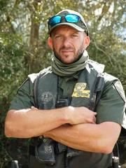 Scott Dupre poses for a photo in front of a group of trees in Louisiana.