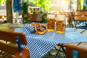 Beer mugs with fresh pretzels or brezen at Oktoberfest, Munich, Germany