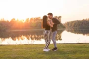 Romantic, social dance and people concept - young couple dancing a tango or bachata near the lake.