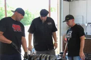 Big Chief, Shawn, and Jeff Lutz do some final maintenance on the Crowmod's engine.