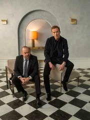 (L-R): Paul Giamatti as Chuck Rhoades and Damian Lewis as Bobby "Axe" Axelrod in BILLIONS Season 5. Photo Credit: Mark Seliger/SHOWTIME