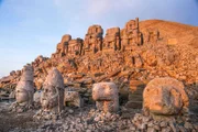 East terrace of Mount Nemrut at sunrise with the head in front of the statues. The UNESCO World Heritage Site at Mount Nemrut where King Antiochus of Commagene is reputedly entombed.