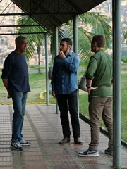 Joe Toft, Doug Laux, and Ben Smith have a chat underneath a covered patio in Medellin.