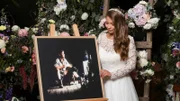 Bindi Irwin standing next to an easel with a photo of her father Steve Irwin