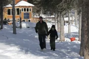 Jeremy Keller and his son Bjorn Keller walking to check on their dogs.
