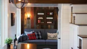 Jennifer Muny's tiny home is gorgeous and rustic with a spacious living area next to large windows that give her an incredible view of the pond she lives next to, as seen on Tiny House, Big Living.