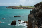 Cabo Rojo, Puerto Rico, USA: Overlooking the Carribean Sea from the limestone cliffs on the southwestern tip of Puerto Rico, with Cabo Rojo Lighthouse in the distance.