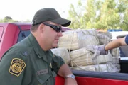 Roma, Texas, USA: Supervisory Border Patrol Agent David Maibaum leaning on a pickup truck carrying bundles of marijuana that were seized from an abandoned house.