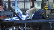 Pelletier employee in shop welding metal bars.