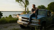 Glenn contemplates the American Dream sitting on hood of his truck at dusk.