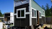 Charli Schmidt's tiny house build has made tons of progress with the exterior siding almost complete featuring gorgeous, seafoam green metal siding that was salvaged from a 120 year old barn on San Juan Island, Washington, as seen on Tiny house, Big Living.