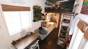 Newlyweds and tiny house owners Chris and Brianna have the perfect, custom tiny house that fits all of their needs with a cozy bedroom loft, spacious dining area and gooseneck living room, as seen on Tiny House, Big Living.